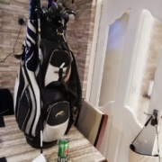 Golf bag on table with can of beer