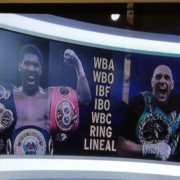 Two boxers showing their prize belts