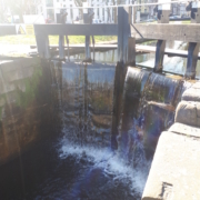 Canal lock gate with water flowing through