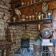 Old kitchen with stove and bottles of herbs on shelves