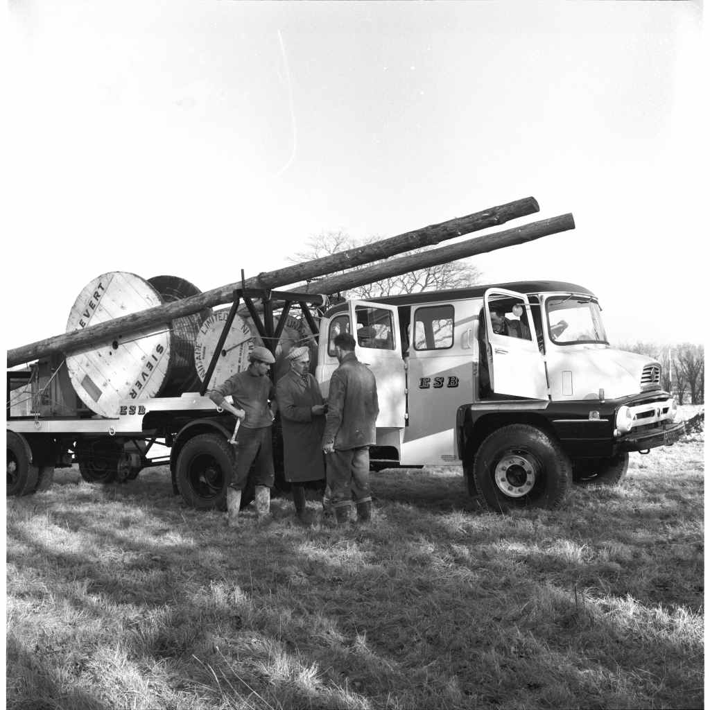 old truck with men standing beside it