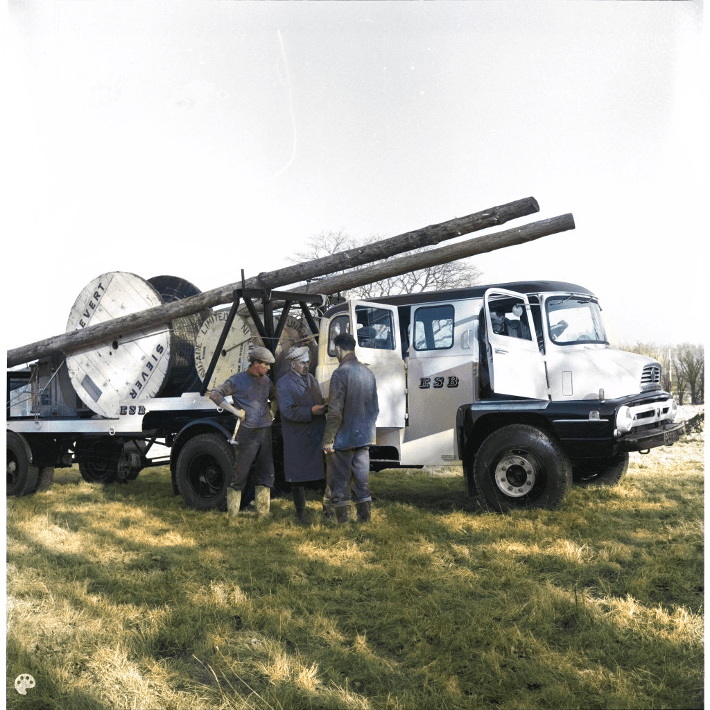 old truck with men standing beside it